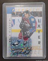 Front of René Corbet autographed card in sleeve