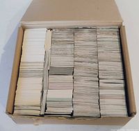 Closed cardboard box showing tightly packed stacks of trading cards viewed from top