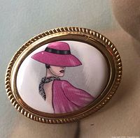 front view showing painted lady cameo and gold frame