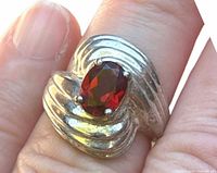 Front view of sterling silver ring showing oval garnet and ribbed shoulders