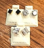 All three pairs of sterling silver stud earrings on display cards