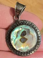 Front view of pendant showing abalone shell and dotted bezel
