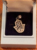 front view of sterling silver Hamsa pendant in case