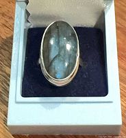 Front view of sterling silver labradorite ring in box