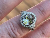 Top view of ring showing large clear CZ center stone and halo of small stones