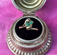 Front view of the 10K gold ring showing two marquise emeralds and diamond accent