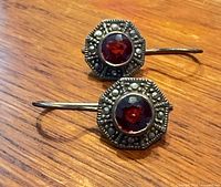 Both earrings front view showing red stones and marcasite detail