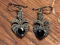 Front view of both earrings showing heart onyx cabochons, marcasite setting and hooks