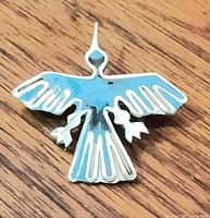 Front view of enamel sterling Thunderbird brooch