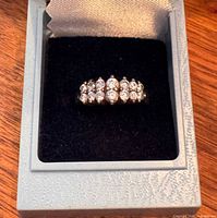 Front view of the ring in box showing cluster of nine cubic zirconia stones