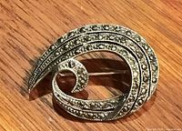 Front view showing swirl design and marcasite stones