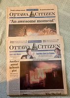 Front pages of both newspapers showing millennium fireworks and headlines