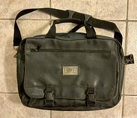 Front view of Accent black bag with Accent logo and buckle straps