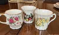 Three floral bone china mugs front view