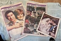 Three newspapers laid out, showing cover photos and titles referencing The Royal Wedding