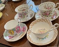 All four teacup and saucer sets on table