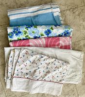 All five folded flat sheets displayed together