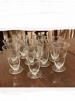 All nine matching footed crystal glasses displayed on table