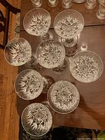 top view of eight cut crystal coupe glasses showing starburst pattern