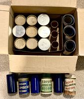 Box containing cylinders, some in tubes