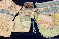 All items laid out showing change pads, blankets, crib sheets, cloth book, bottle holder