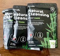 Front view of three sealed Banddo Natural Cleansing Foot Pads packs