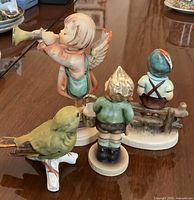 Rear view of all four figurines showing size and detail