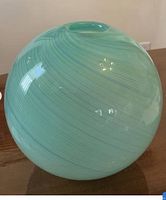 Full view of green swirled glass globe vase