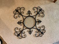 Front view of iron filigree frame on carpet