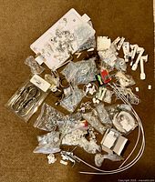 overview of assorted drapery hardware and rods spread on floor