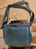 Black padded carrying case front view with shoulder strap