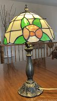 Side view of stained glass table lamp on table