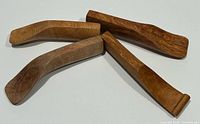 Four wooden spoons laid out showing handles and overall shape