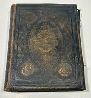 Front cover showing embossed leather design and portrait medallions