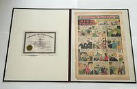 Open folio showing COA and comic page