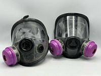 Both Honeywell full-face respirators front view with attached purple P100 cartridges