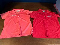 Both Nike polo shirts laid flat