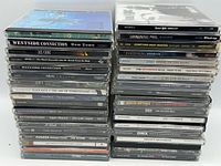 Two stacks of jewel-case CDs, front spines visible