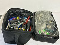Overview of open tool bag showing mixed tools in two compartments