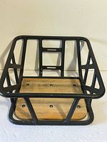overall view of metal bicycle basket with wooden base