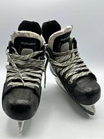 Front view of both skates showing tongues, laces, toe wear