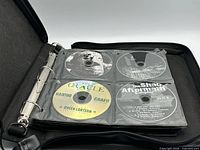Binder open with first four CDs