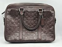 Front view of Coach embossed leather bag showing overall design