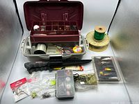 Overall view of tackle box, line spools, knife, mini box, blister pack