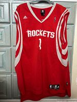 Front of red Houston Rockets jersey displaying ROCKETS text and number 1