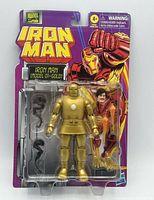 Front of sealed blister card showing gold Iron Man figure and accessories
