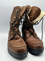 Front view of both boots showing uppers, laces, toes, and soles