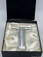 Pollen press resting in satin-lined box