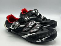 Side view of both shoes showing buckle, straps, logos