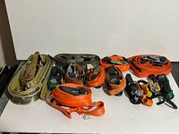 All eight coiled ratchet straps arranged side by side on white backdrop